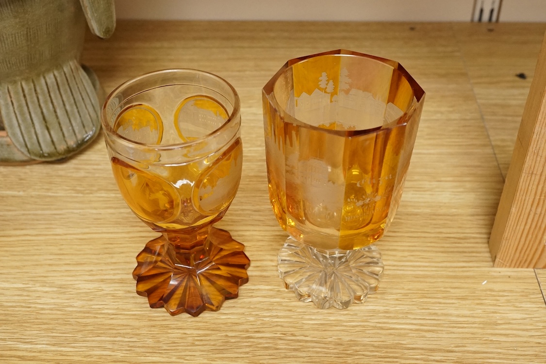Two Bohemian topographical engraved amber flashed spa glasses, late 19th century, largest 13.5cm high